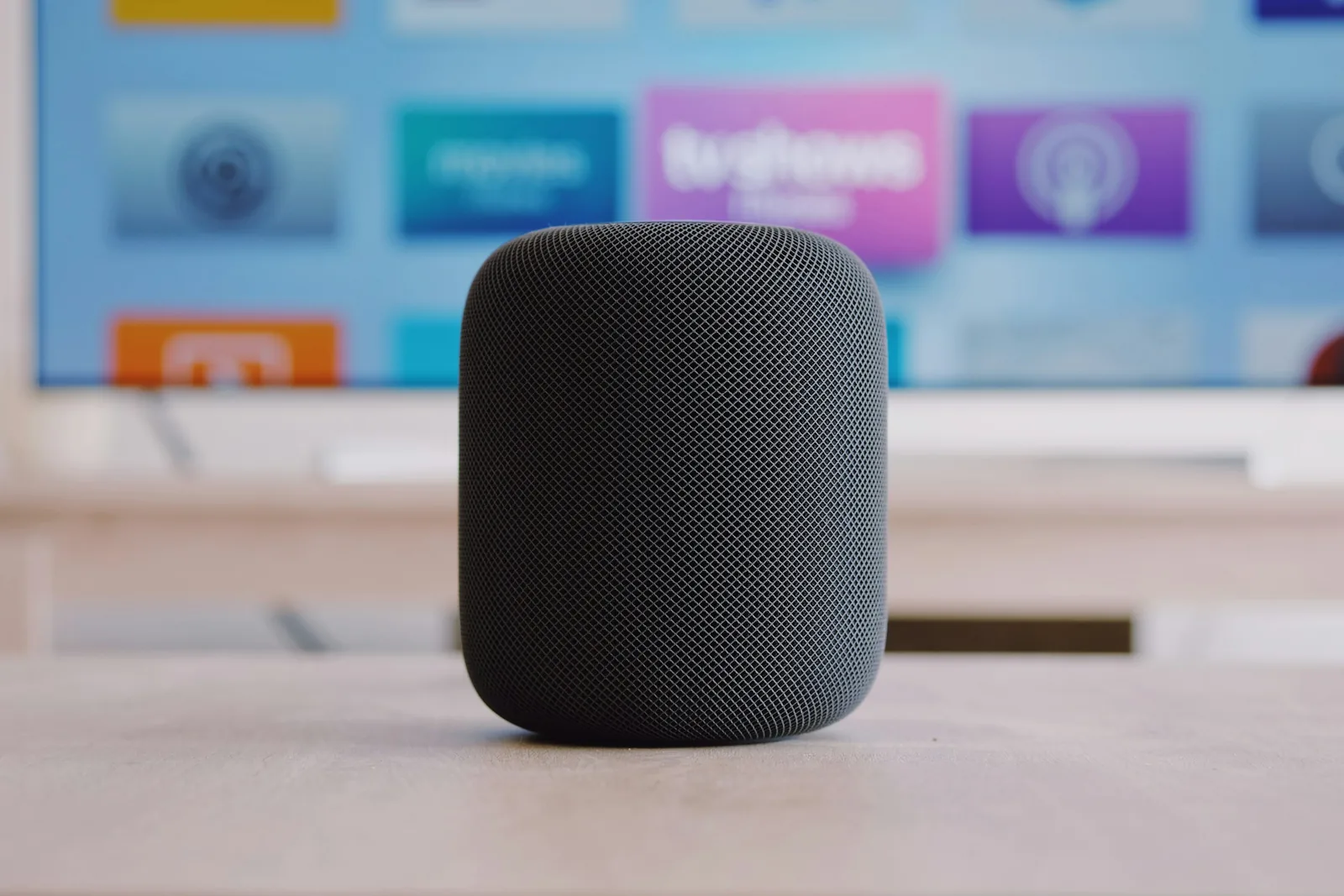A black smart speaker on a table